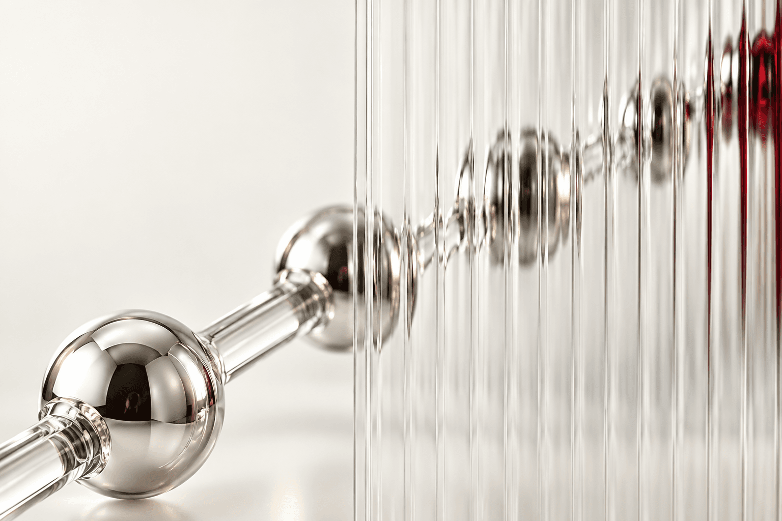 Chrome molecular sculpture behind optical glass from the Plat Bio Labs storefront